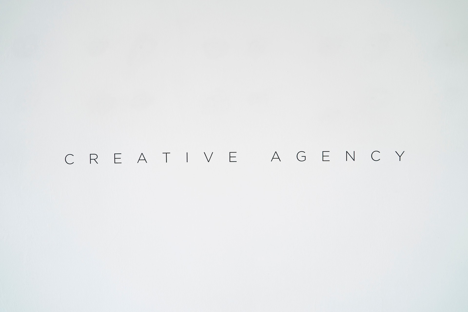Creative agency vinyl typed word on white wall