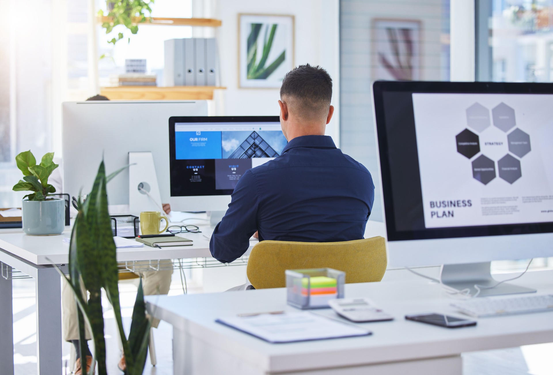 Rearview shot of a designer working on his computer